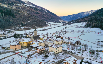 Aerial view of snow-covered Pellizzano in Trentino-Alto Adige, Italy, during winter twilight.